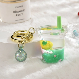 Macro shot of liquid acrylic strawberry keychain with green glitter and golden ring
