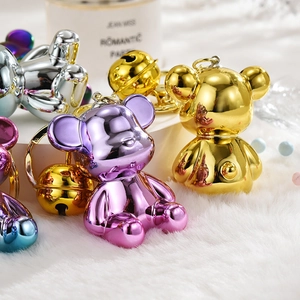 Macro detail of metallic gradient acrylic bear keychains with colorful plating and bells