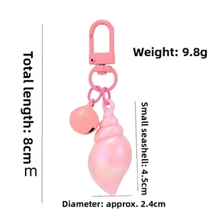 Pink conch keychain with lobster clasp, bell detail and size measurements