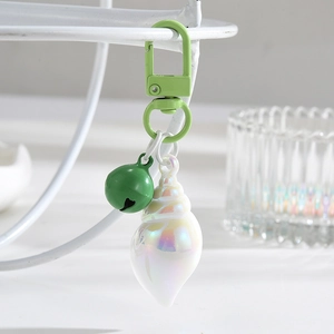 Creative iridescent conch shell keychain with green metal hook and matching bell charm