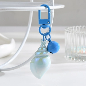 Blue seashell keychain with iridescent coating and bell on a metal hook