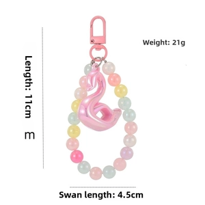Detailed view of pink acrylic swan charm with size dimensions and pearlescent beads