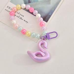 Detail of colorful acrylic beads and aurora swan pendant on a macaron beaded chain