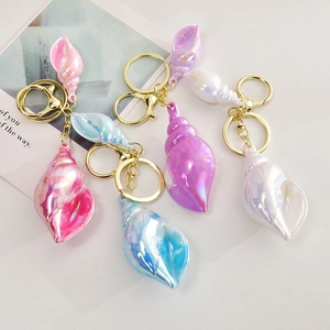 Iridescent seashell keychains in assorted colors with golden rings and lobster clasps