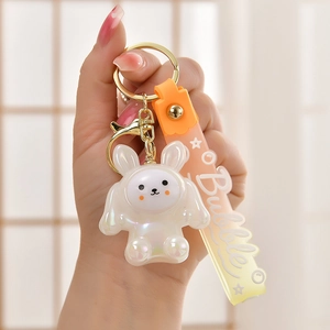 Detail of cute acrylic glowing rabbit keychain with orange gradient Bubble wrist strap