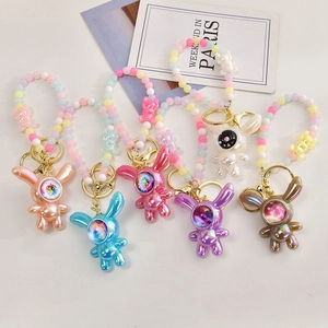 Luminous astronaut rabbit keychain in six metallic colors with colorful beaded straps