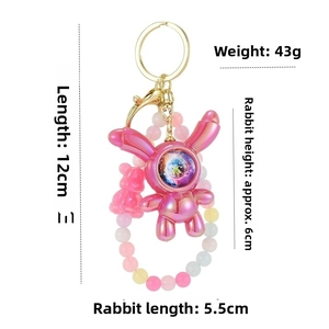 Detail of 43g starry sky astronaut bunny keychain with rainbow bead chain and pink bear charm