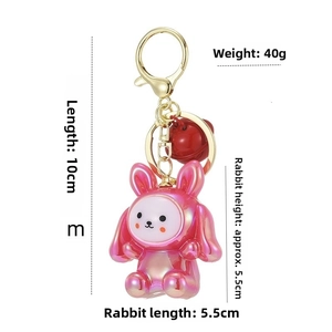 Detailed view of pink acrylic bunny keychain with size dimensions and golden clasp