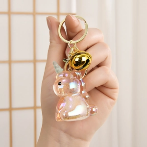 Detail of glitter unicorn keychain with gold bell and translucent resin finish