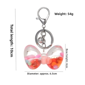 Close-up of bow-shaped liquid quicksand keychain with acrylic beads and measurements