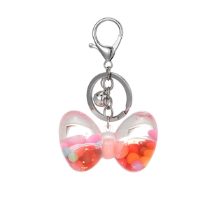 Creative bow-shaped liquid quicksand keychain with colorful beads and silver bell