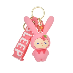 Pink silicone bunny keychain with strawberry hat and SLEEP strap on white background