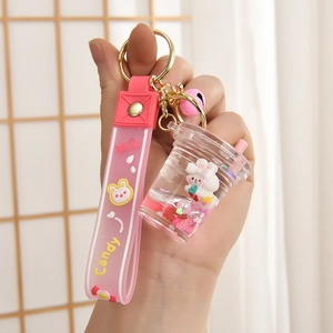 Pink liquid strawberry bunny keychain with silicone hand strap and gold keyring bell