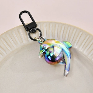 Macro detail of iridescent gradient dolphin pendant with a black metal lobster clasp