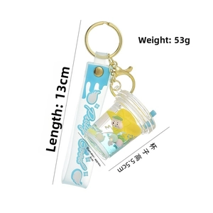 Dettagli del portachiavi a tazza di bubble tea con liquido blu e bambolina gialla carina