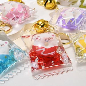 Detailed view of acrylic candy bag keychains with colorful liquid and cute bear charms