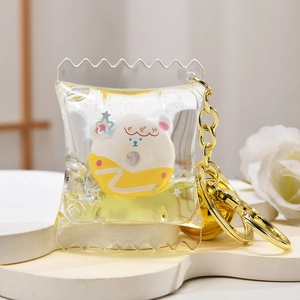Close-up of a creative liquid keychain with yellow glitter and a bear donut inside