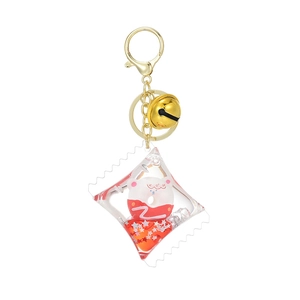 Cute acrylic donut bear keychain with liquid red quicksand and gold bell on white background
