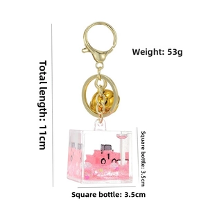 Detailed view of fluid liquid keychain with pink glitter and car miniature in cube