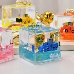Close-up of creative excavator quicksand keychain with colorful liquid and glitter