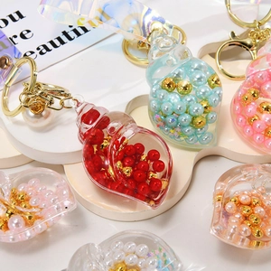 Macro view of shell-shaped acrylic keychains with pearls and golden clasps