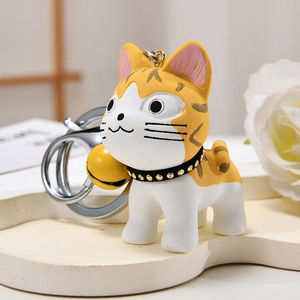 Cute resin orange and white cat keychain with a yellow bell and silver metal ring