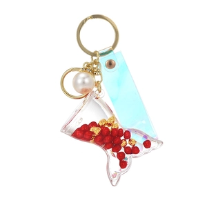 Creative mermaid tail keychain with flowing red beads and holographic PVC strap