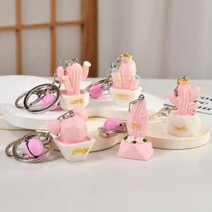 Pink resin cactus and feather keychains with bells and lucky golden lettered bases