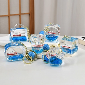 Creative sailboat liquid drifting bottle keychain with blue fluid and star sequins