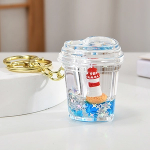 Detailed view of nautical keychain with lighthouse, blue liquid and silver glitter