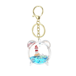 Acrylic quicksand keychain with blue liquid and lighthouse lighthouse inside a clock frame