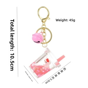 Detail of liquid quicksand kitten charm with pink bell and golden lobster clasp