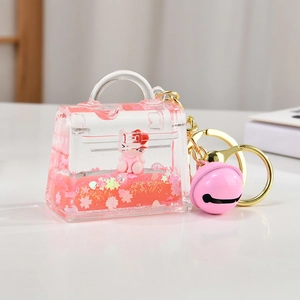 Cute pink liquid quicksand cat doll keychain with cherry blossoms in a mini bag shape