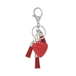 Red heart keychain with suede tassels and silver metal clasp on a white background