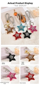 Detail view of colorful star-shaped rhinestone keychains with tassels and metal clasps