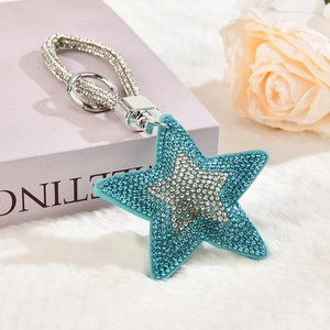 Macro detail of star keychain with light blue rhinestones and sparkling woven strap