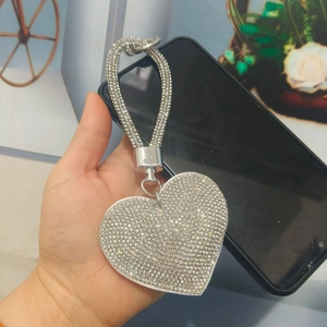 Close-up of sparkling heart keychain with white rhinestones and matching crystal strap