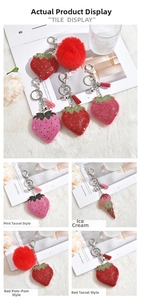 Detail of red strawberry keychain with sparkling rhinestones and matching soft tassel charm