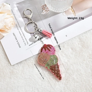 Detail view of ice cream cone keychain with pink tassel, rhinestones, and size dimensions
