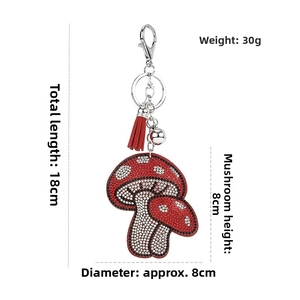 Detail showing red mushroom rhinestone keychain dimensions with red tassel and bell
