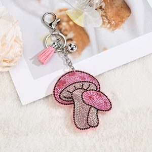 Pink mushroom keychain detail with sparkling rhinestones and matching leather tassel