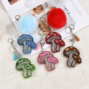 Sparkly rhinestone mushroom keychains with plush fur pom-poms and tassels in five colors