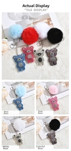 Detail view of sparkly rhinestone bear keychains with fluffy fur balls in multiple colors