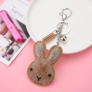 Sparkling rhinestone rabbit keychain with light brown suede finish and tassel detail