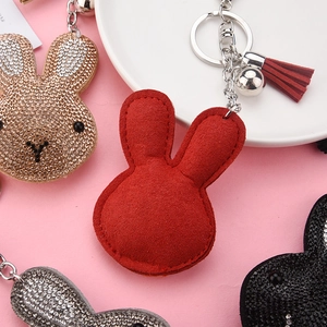 Detailed view of colorful velvet and rhinestone rabbit keychains with matching tassels