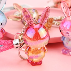 Macro shot of a pink gradient resin bunny keychain with glitter and rhinestone strap