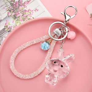 Detail of pink acrylic faceted crystal bunny keychain with diamond rope and blue star charm