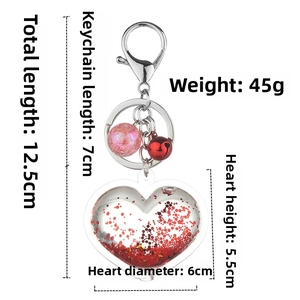 Macro view of heart liquid glitter keychain with bell and size measurement lines