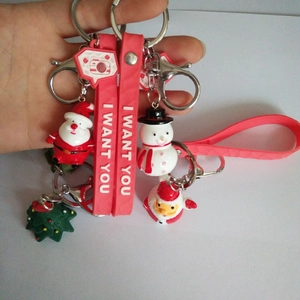 Close-up of cute snowman and Santa keychain with I WANT YOU red silicone wristlet strap