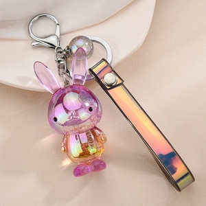 Detail of colorful acrylic rabbit keychain with iridescent laser strap and silver clasp